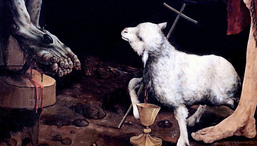 Dettaglio della Crocefissione di Grünewald, agnello immolato ai piedi di Gesù Crocefisso